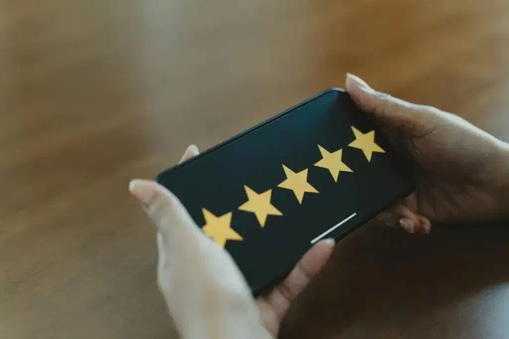 Customer review good rating concept, smile face and five star on screen for positive feedback.