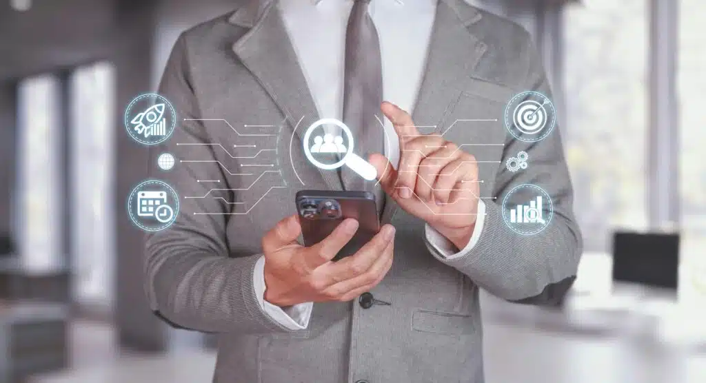 Businessman Using Smartphone for SEO Analysis in Modern Office Setting